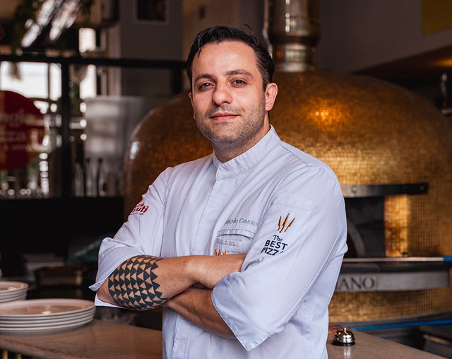 Antonio Cavoto in front of the wood-fired oven